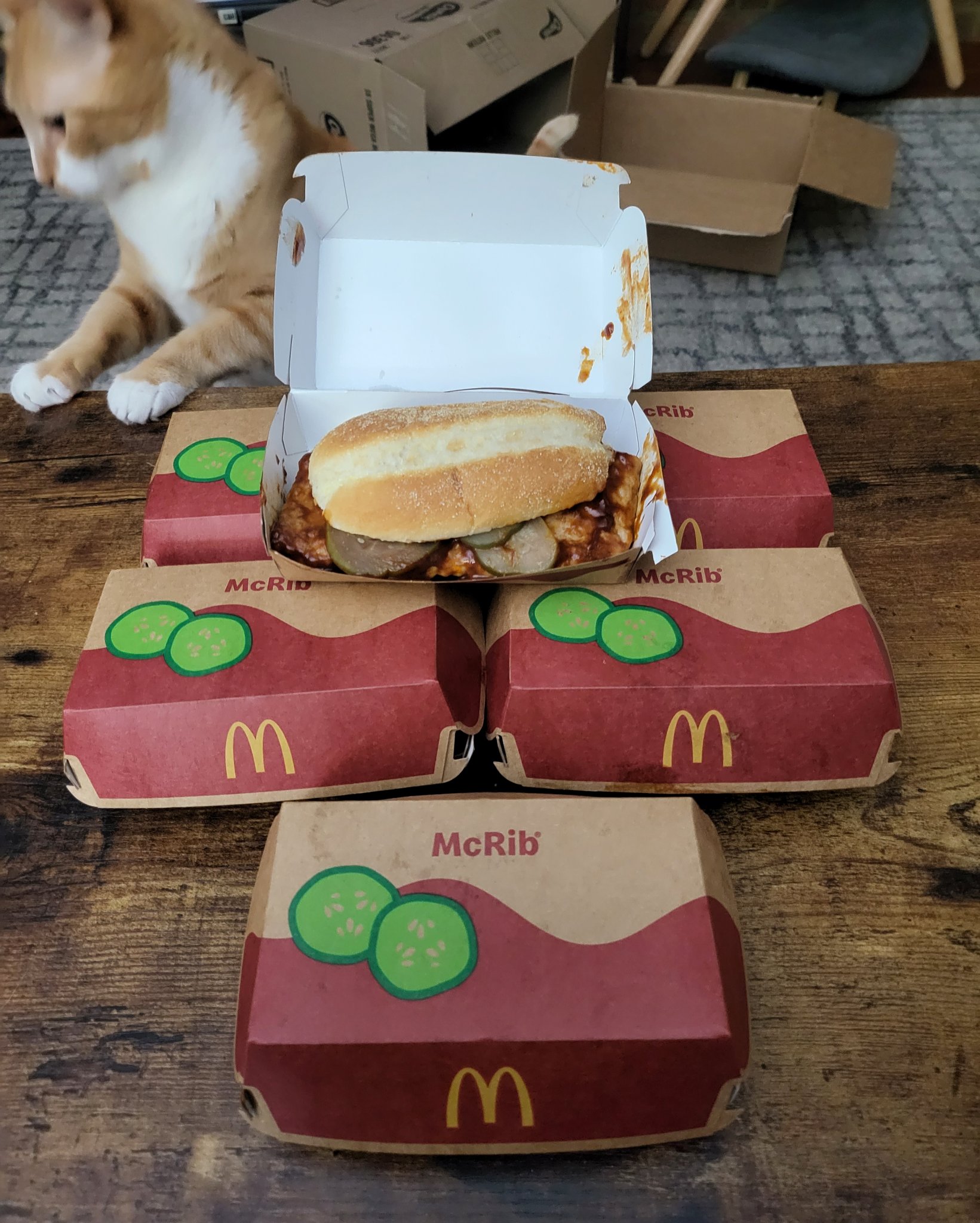 McRib is back! — a stack of McRib boxes at home — the cat looks on, Sat · Nov 11, 2023