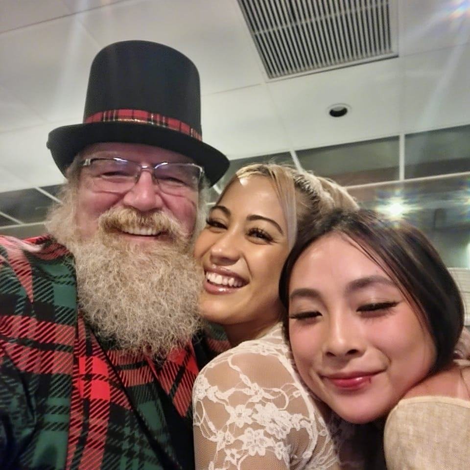 Stage Christmas Party — Jeffry in top hat and plaid jacket with two women — from the Christmas collection