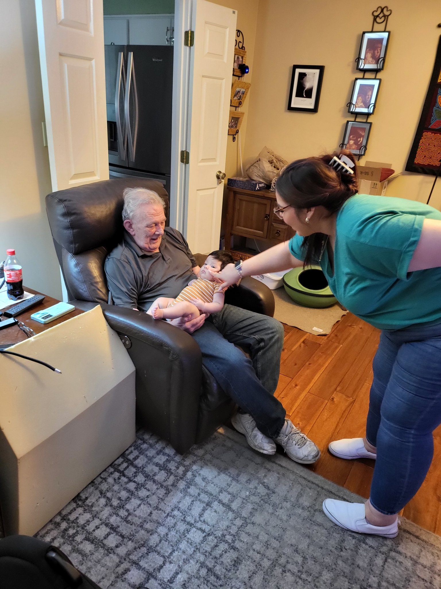 A visit with the grandkids — the wider shot of Bob in the recliner with the baby, Sun · Aug 18, 2024