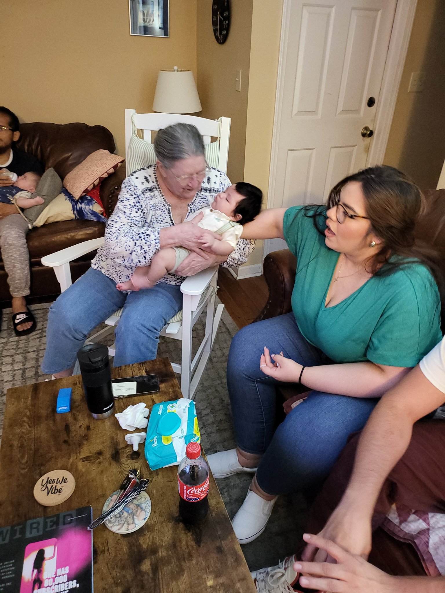 A visit with the grandkids — Gail in the rocking chair holding the baby while Laura leans in, Sun · Aug 18, 2024