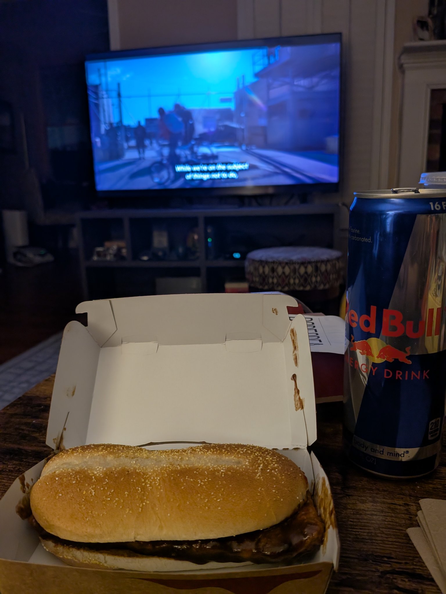 McRib is back! — the McRib in its open box at home, the TV on behind, Mon · Dec 1, 2025