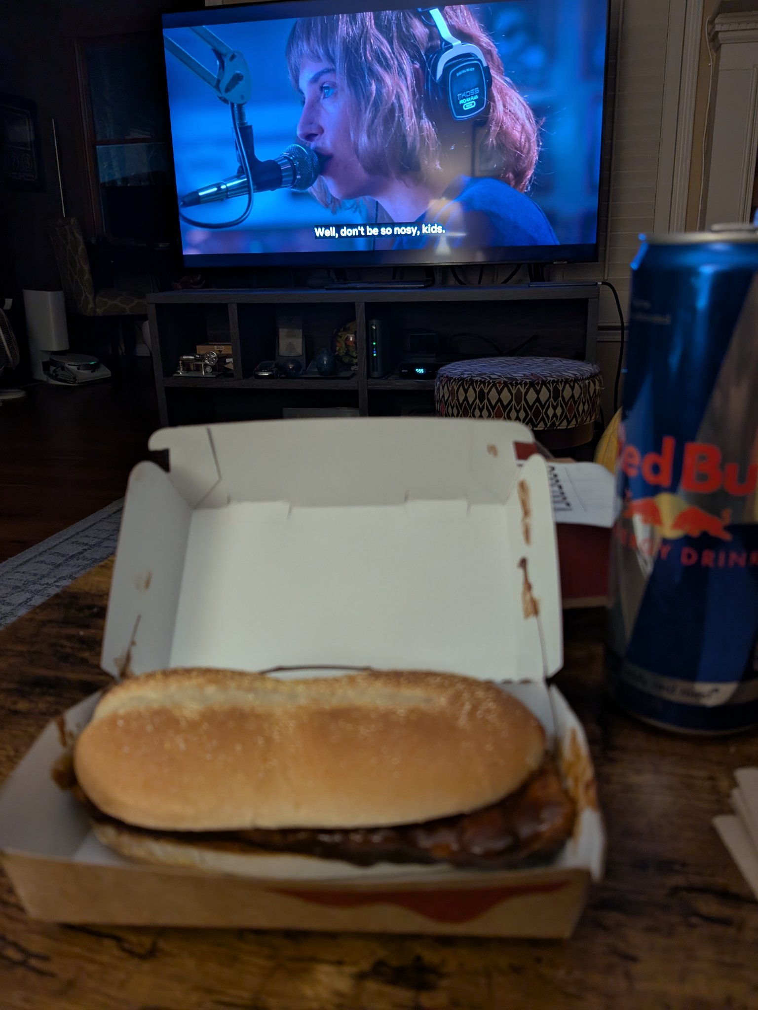McRib is back! — the McRib in its open box at home, the TV on behind, Mon · Dec 1, 2025