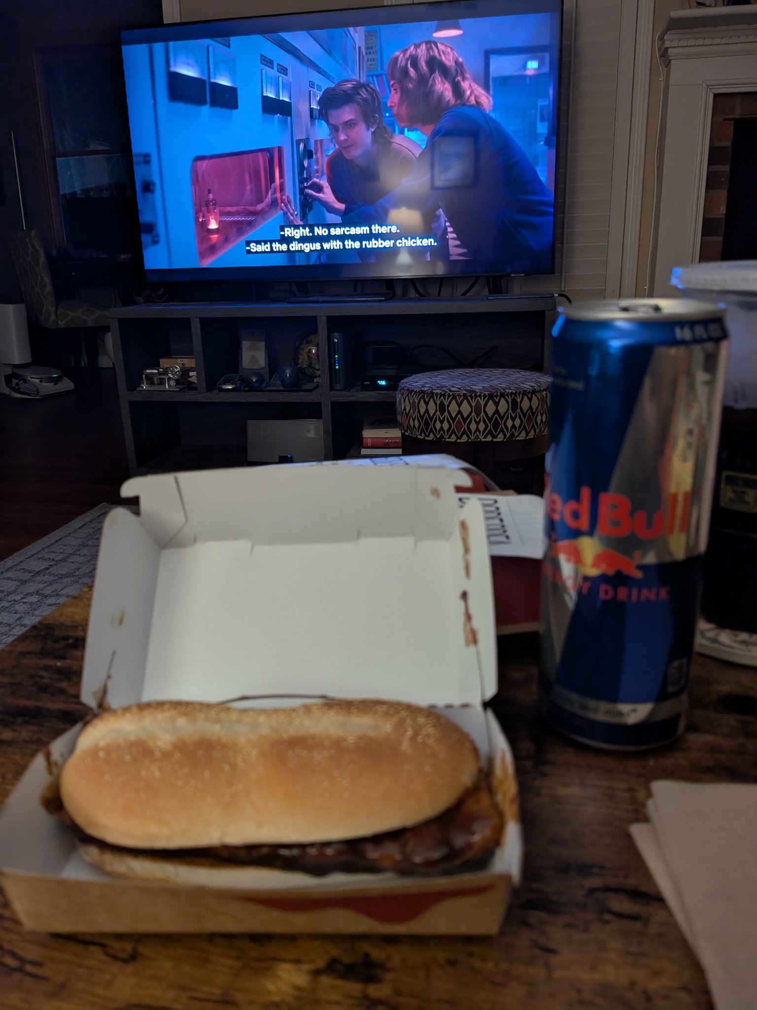 McRib is back! — the McRib in its open box at home, the TV on behind, Mon · Dec 1, 2025